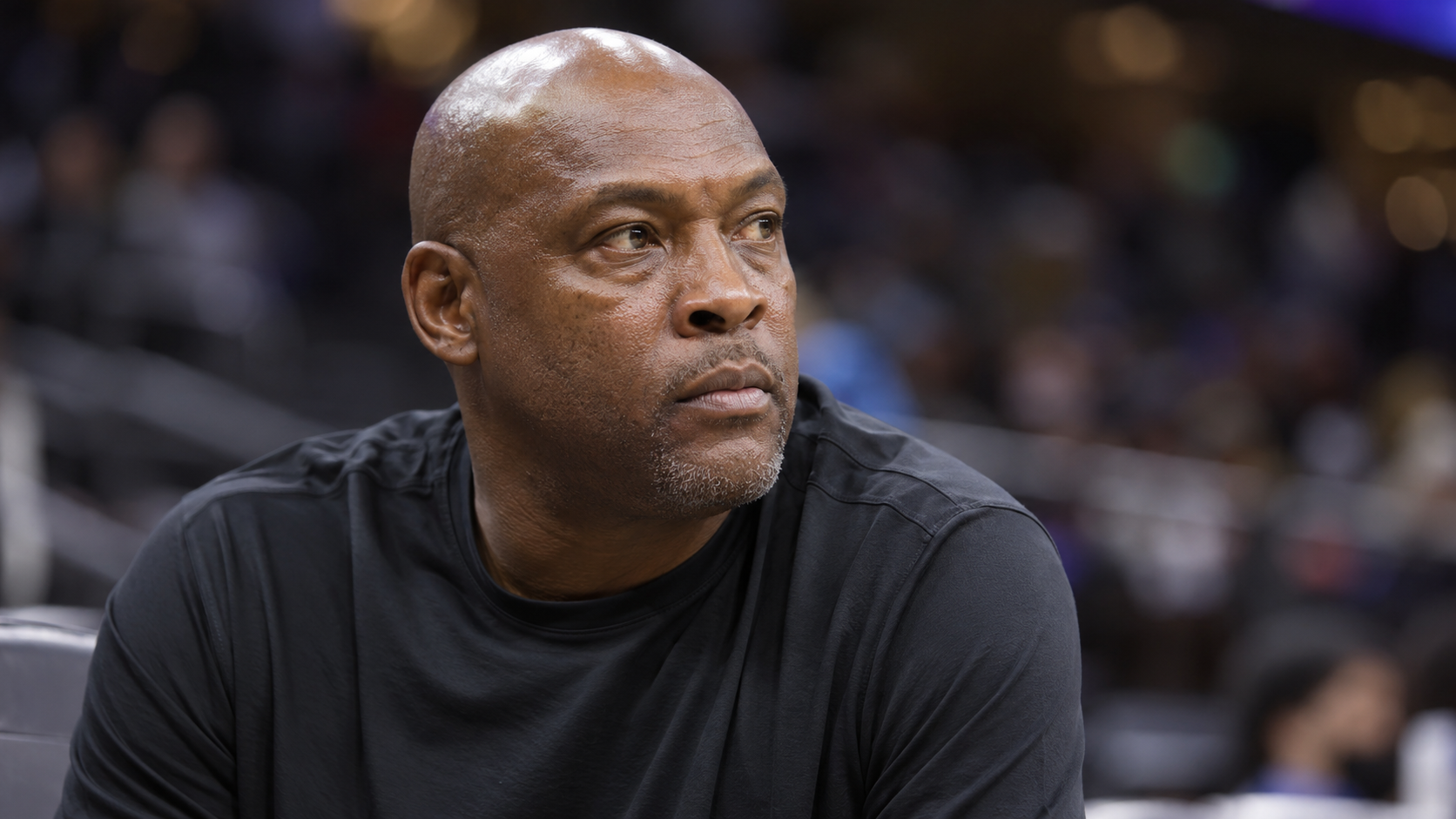 Photorealistic editorial portrait of Mitch Richmond under basketball arena lights