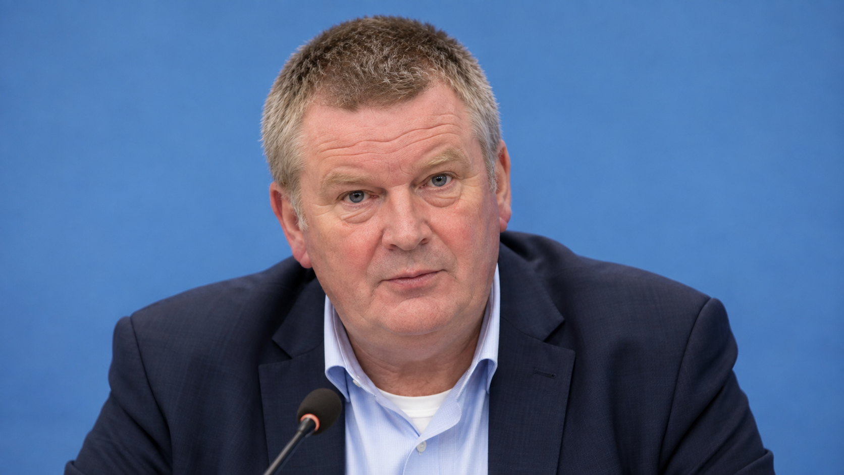 AI-created realistic portrait of Michael Ryan in an emergency planning briefing room.