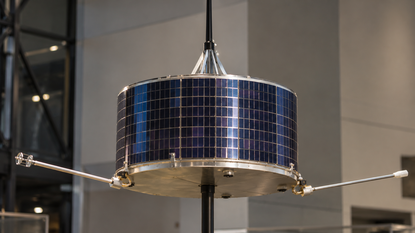 Historical reconstruction of a Pioneer 6 type exhibit model with a solar-cell drum, axial antenna, and instrument booms.