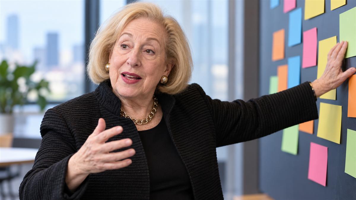 AI-generated editorial portrait of Rosabeth Moss Kanter facilitating organizational change