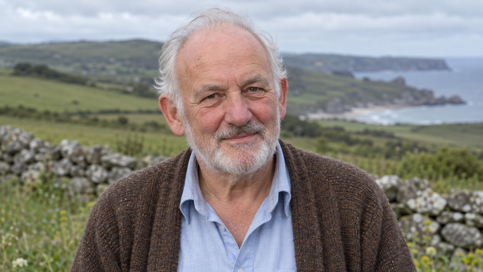 AI-generated realistic portrait of Julian Tudor Hart on a recreated Welsh coastal landscape.
