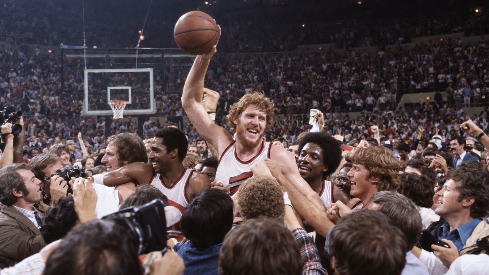 Photorealistic historical reconstruction of Portland basketball players celebrating their 1977 championship before a jubilant home crowd.