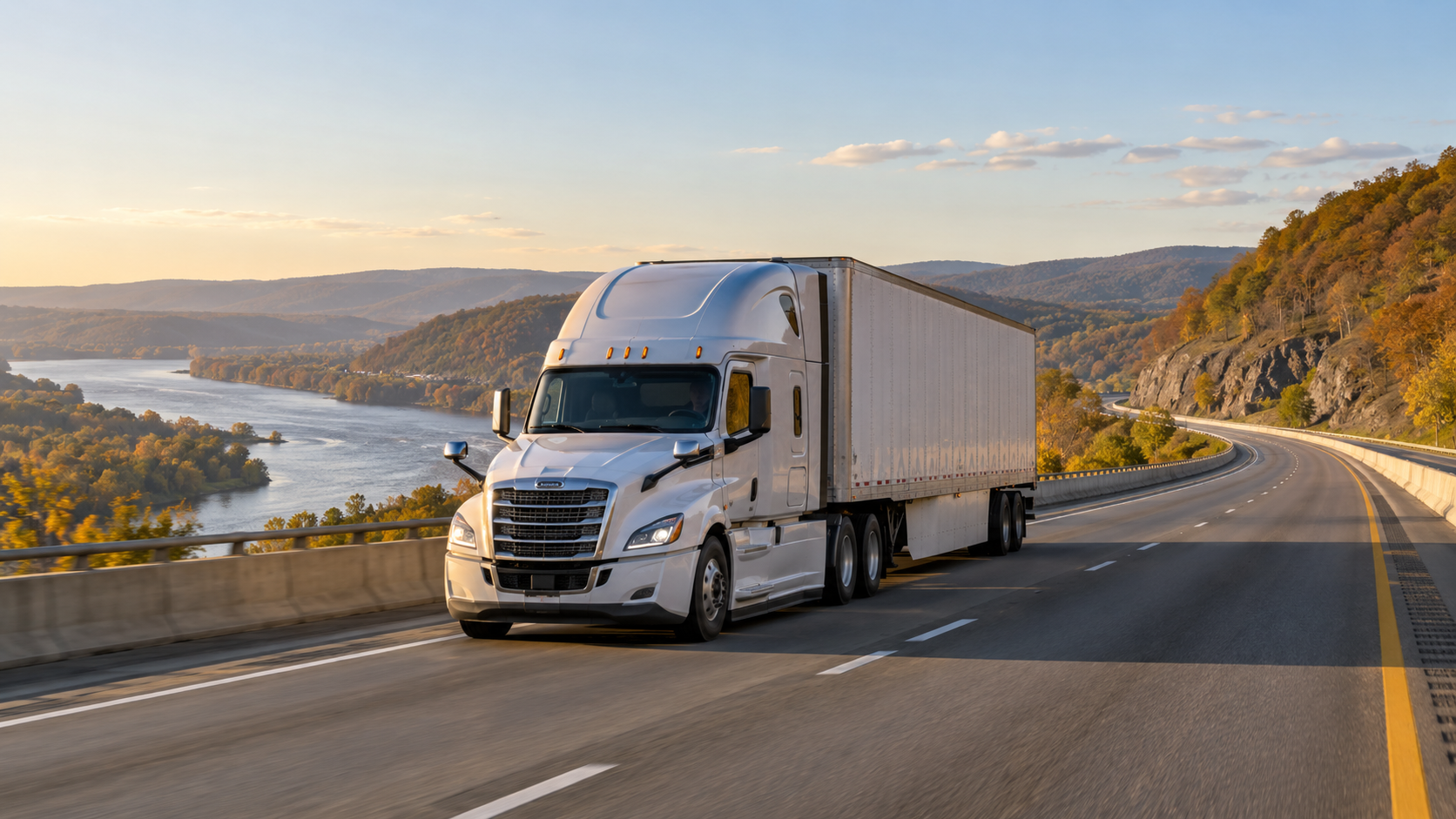 A freight truck on an interstate highway through a state boundary landscape