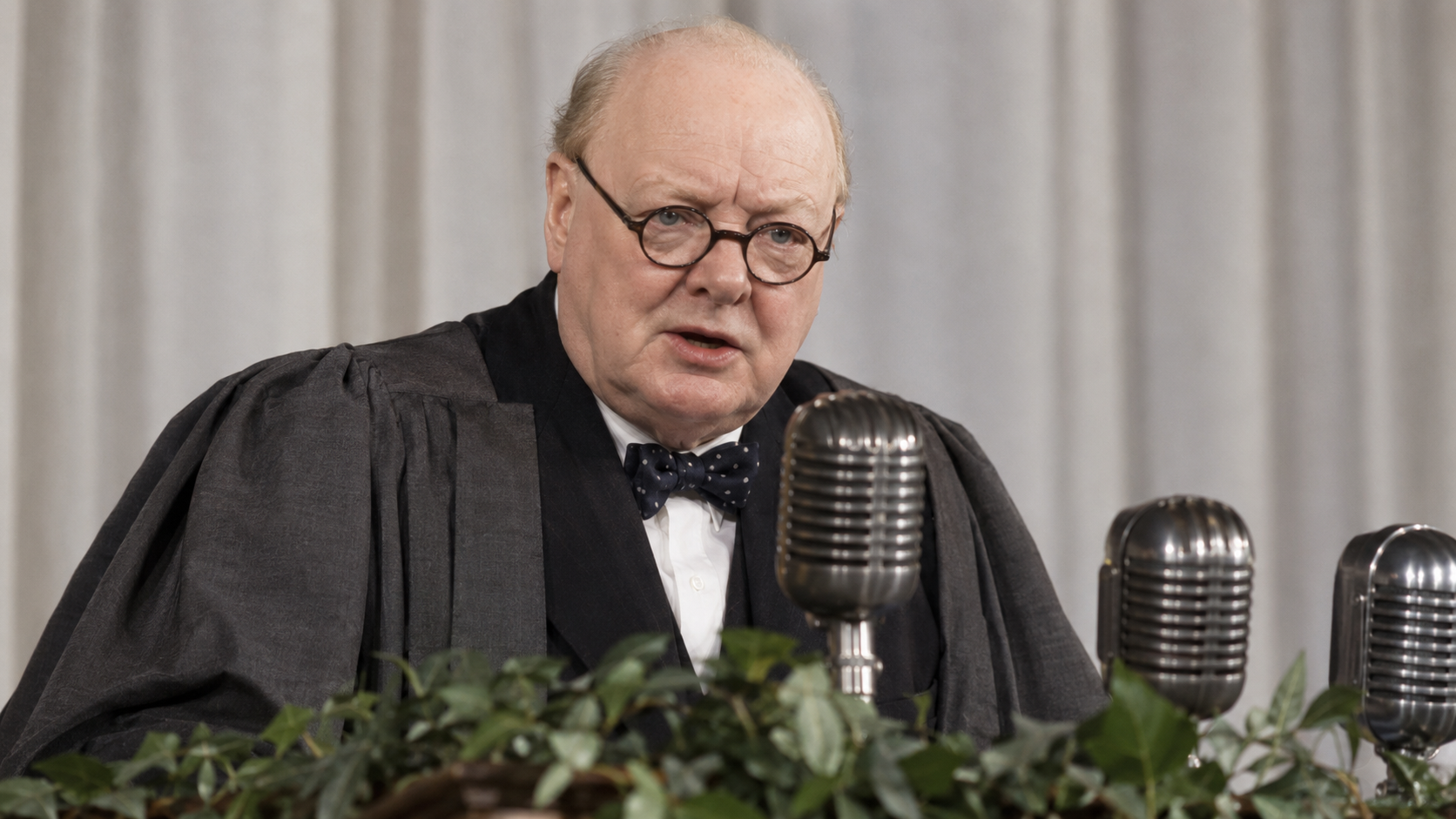 Historical reconstruction of Winston Churchill in academic dress speaking at Fulton in 1946.