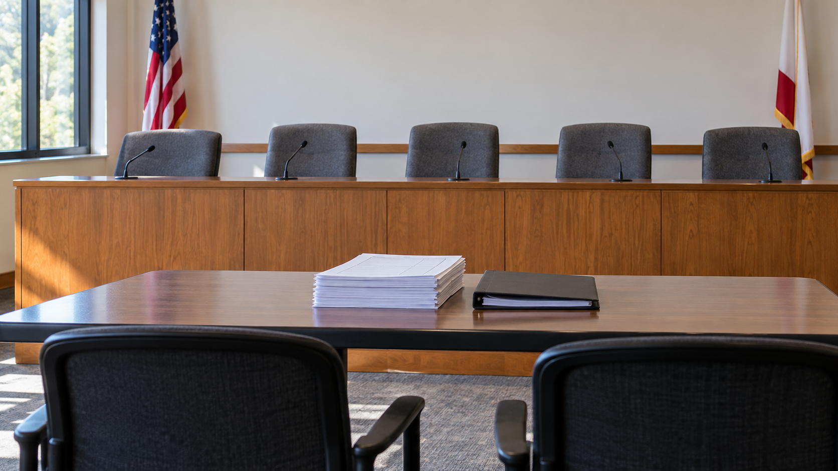 An empty canvassing-board room with five chairs and anonymous summary papers