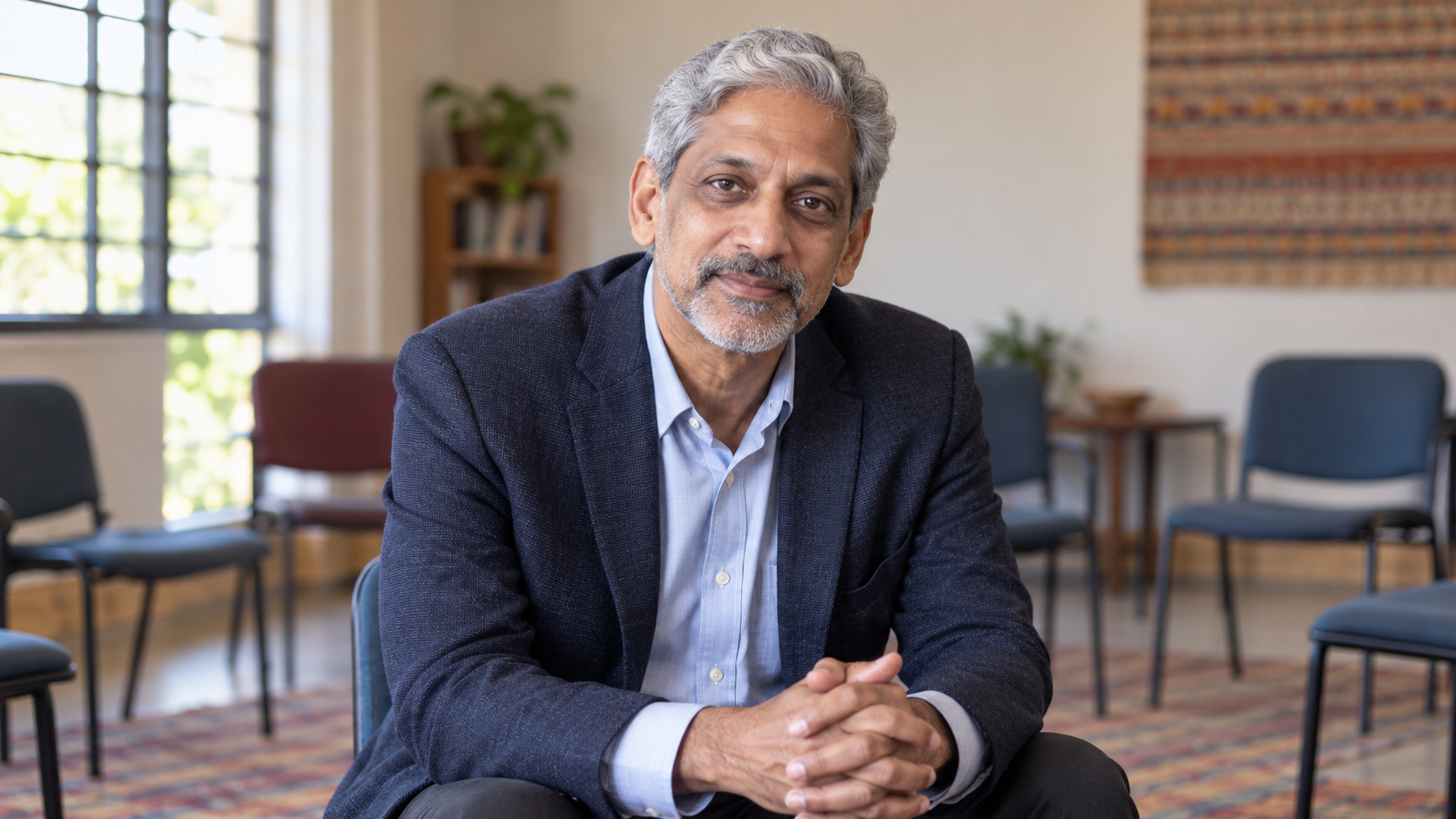 Vikram Patel in a community mental-health training room with chairs arranged for conversation
