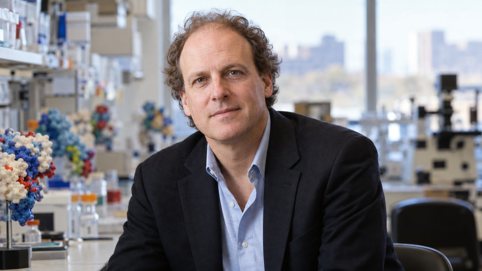 Jay Bradner in a cancer epigenetics laboratory with molecular models softly blurred